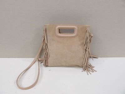 beige sued bag with fringes and a handle on a white surface