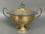an antique silver plated bowl with a lid and handles