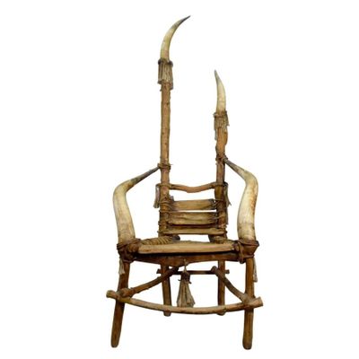 a wooden chair with horns on the back of it