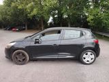 a small black car parked on the side of the road