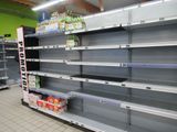 many empty shelves in the store with drinks on them