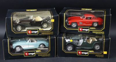 three toy cars are sitting in a box on a black surface