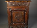 an old wooden cabinet with a carved design on the front