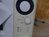 a microwave that is sitting on a table with a piece of paper
