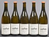 six bottles of wine are lined up on a table