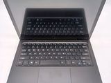 a laptop that is open on a white surface
