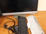 an image of a computer desk with a keyboard and a monitor