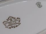 a white plate with a brown design on it