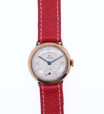 a close up of a wrist watch with a red strap