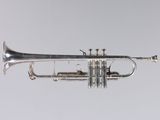 an old silver trumpet with a silver bell on a white background