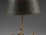 a silver plated table lamp with a black shade on it