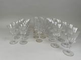 many wine glasses sitting on a table with a coin