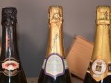 three bottles of champagne are lined up on a table