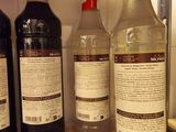 several bottles of alcohol are lined up on a counter top