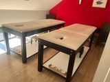 a picture of a massage room with a table and chairs