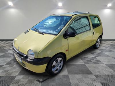 a picture of a small yellow car parked in a garage