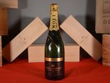 a bottle of champagne sitting on a table next to wooden boxes