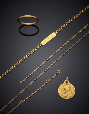 a collection of gold jewellery including a coin, a ring and a bracelet
