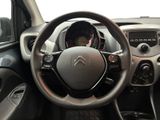 the interior of a car with a steering wheel and dashboard controls