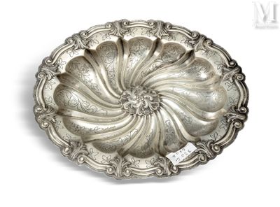 an antique silver plate on a white background with a tag on it