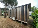 an image of a tiny house in the middle of the woods