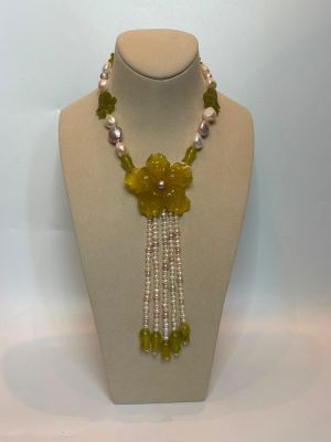 Collier de perles jaunes et blanches orné de fleurs et de perles, présenté sur un mannequin