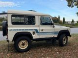 a picture of a white land rover parked on the side of the road