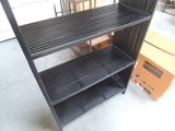 a black shelf that has a bunch of shelves on top of it