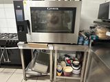 un micro-ondes posé sur un support dans une cuisine