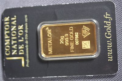 a gold bar in the package on the table