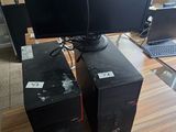 three computer monitors sitting on a desk with a laptop