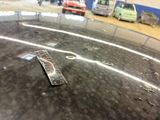 a remote control sitting on top of a table in a parking lot