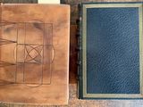two books sitting on top of a wooden table next to each other