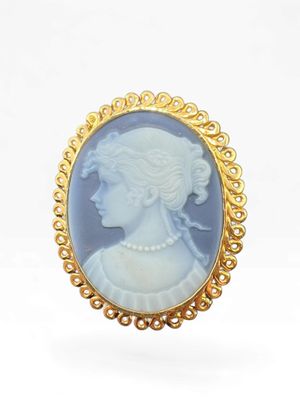 an image of a woman ' s profile is shown in a gold - plated broocher