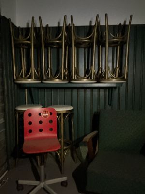 une chaise rouge posée devant une pile de chaises