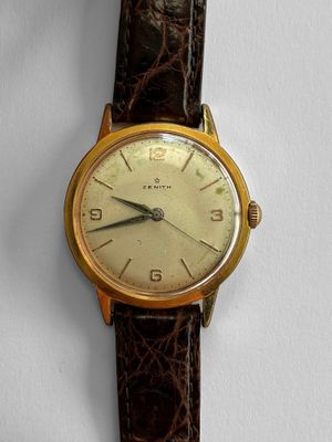 an image of a close up of a wrist watch on a white surface