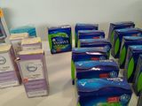 several boxes of toothpaste sitting on a table next to a computer