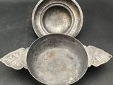 two metal bowls and a bowl with wings on them