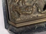 a bronze statue of a man and a woman on a horse