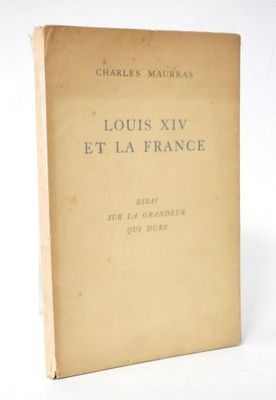 an old book sitting on top of a table next to a white wall