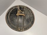 a gold plate with a horse on it on a white surface