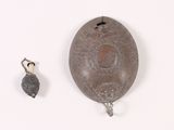 a metal object that is sitting next to a small object