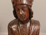 a wooden bust of a man with a hat on