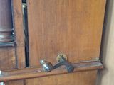 a wooden cabinet that has a clock on top of it