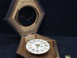 a small wooden box with a clock inside of it