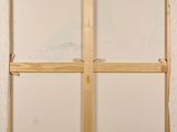 an image of a painting of a cross on a white wall