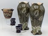 three vases that are sitting on a clear shelf