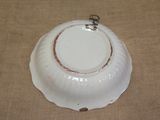 a white bowl with a brown rim on a table