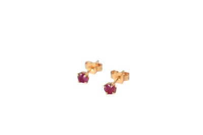 a pair of gold and ruby earrings on a white background