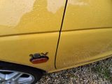 a close up of a car door handle with a cat on it